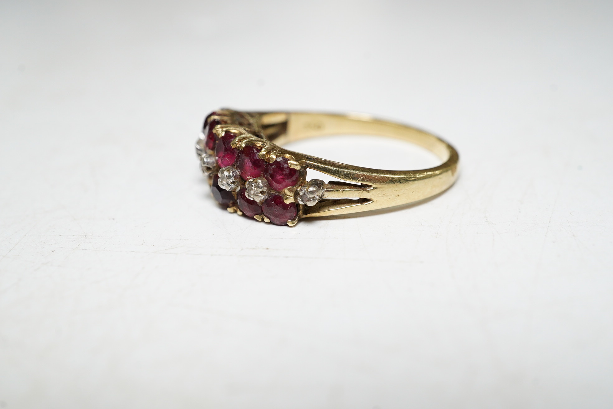 An 18k ruby and diamond set dress ring, one ruby missing, size M, gross 3.7 grams